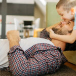 a father and son play after their air conditioning service is completed by an ac company near me