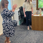 Applause for Holly Kaufmann, assistant superintendent for school operations and student services in the Catholic Schools Office of The Roman Catholic Archdiocese of Washington, applauds during a surprise visit to the ninth grade religion class of Holly Kaufmann, at right, of St. Mary’s Ryken High School in Leonardtown, when it was announced that Kaufmann is a 2024 Golden Apple Award-winning teacher.