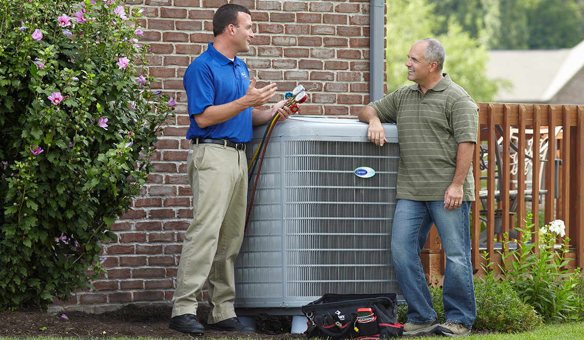 carrier dealer discusses central air repair options with homeowners