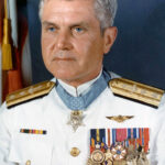 U.S. Navy Rear Admiral James Bond Stockdale in dress white uniform, adorned with numerous decorations.