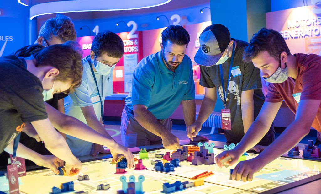 Instructor working with students at a light table