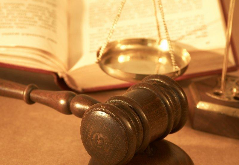 A gavel resting on a dark surface, symbolizing legal proceedings.