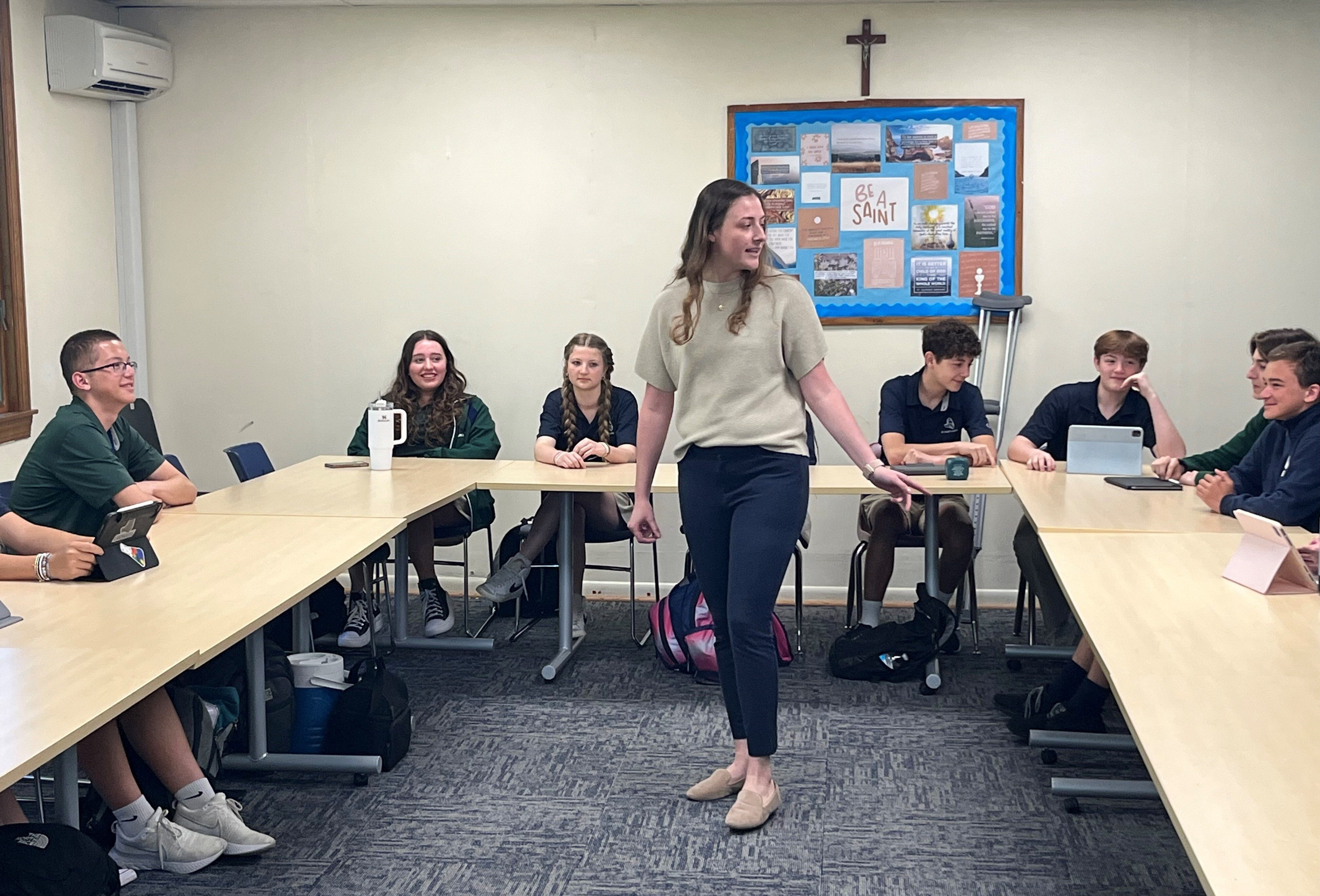 Holly Kaufmann pointing toward students in a class at St. Mary’s Ryken High School in Leonardtown, Maryland, highlighting local educational focus.