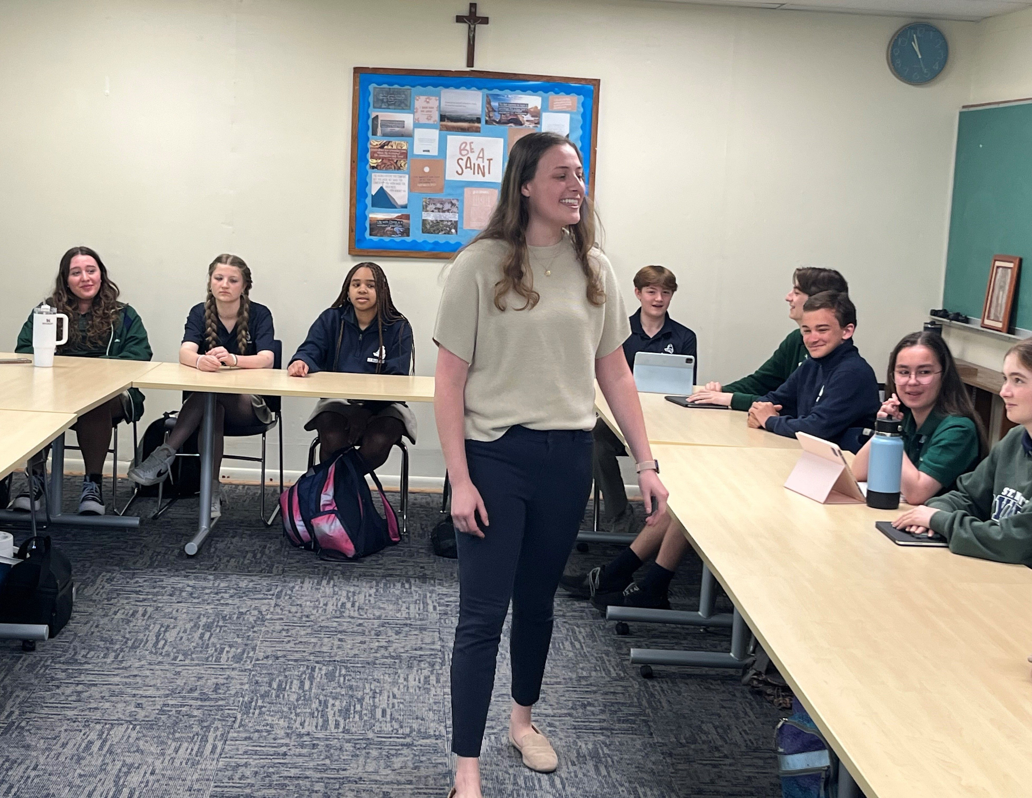 Holly Kaufmann teaching a class to ninth graders at St. Mary’s Ryken High School in Leonardtown, Maryland, emphasizing the importance of education and community in Leonardtown.