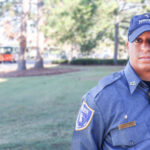 Male Security Officer Standing Guard Outside a Building, Representing Local Security Services