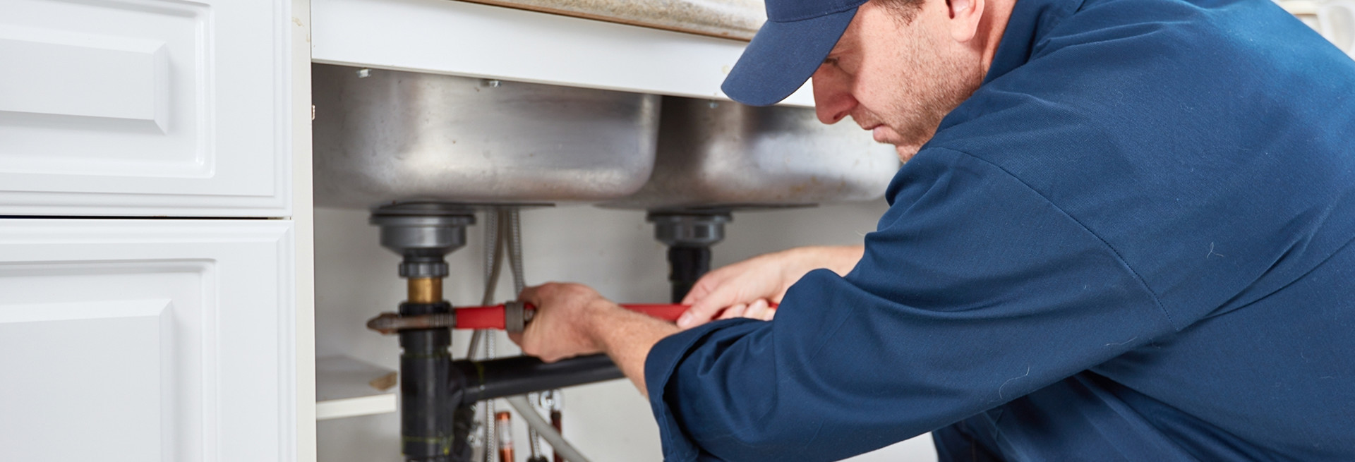 Technician using acoustic listening equipment for leak detection