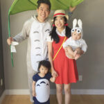 Family cosplay as characters from Studio Ghibli's Totoro, showcasing their handmade costumes and accessories.