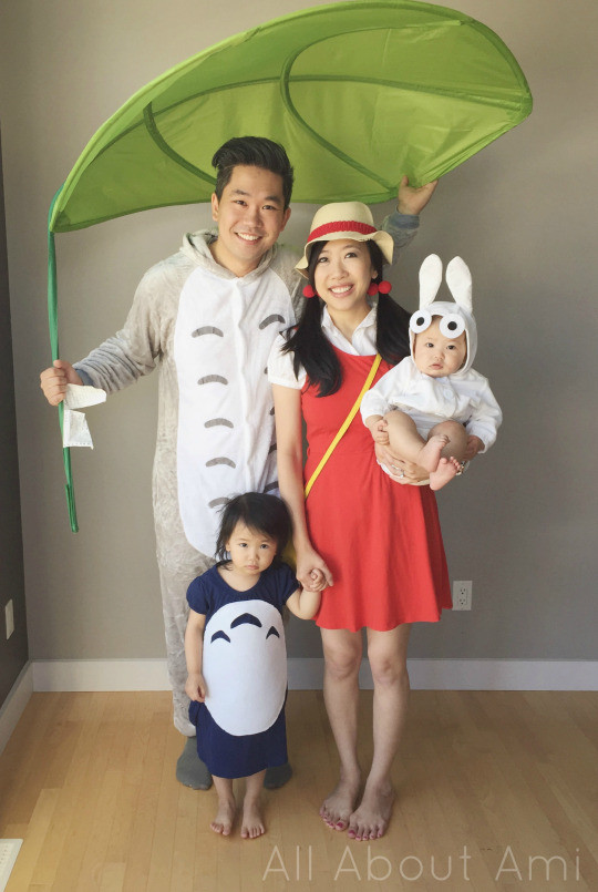 Family cosplay as characters from Studio Ghibli's Totoro, showcasing their handmade costumes and accessories.