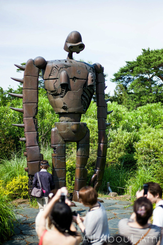 Rooftop garden at the Ghibli Museum featuring a statue inspired by &quot;Laputa: Castle in the Sky&quot; with intricate details and lush surroundings.