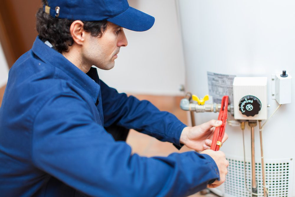 Water heater repair service being performed by a technician.