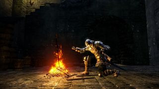 A player lighting a fire in Dark Souls