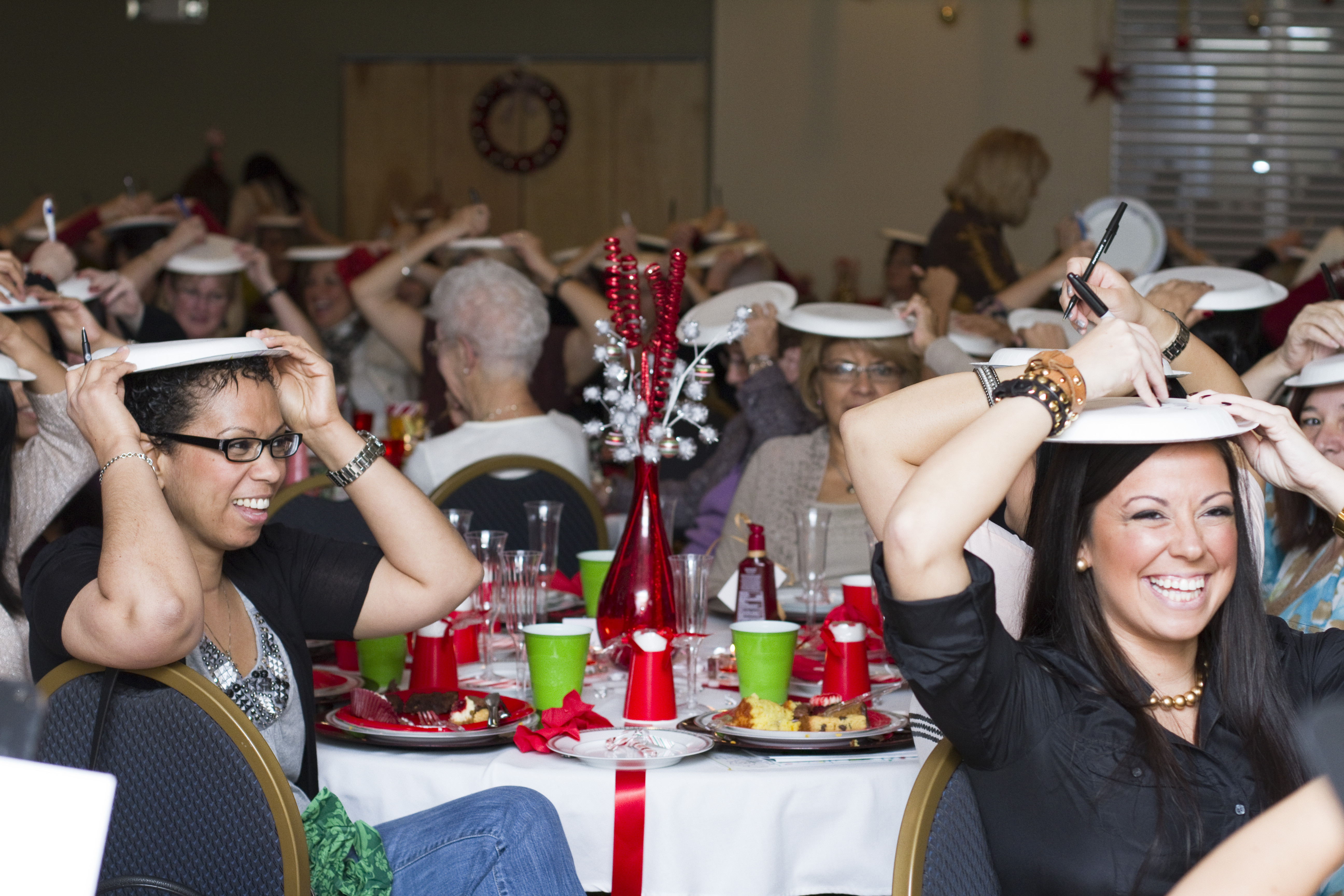 participants laughing at the drawings during the paper plate game