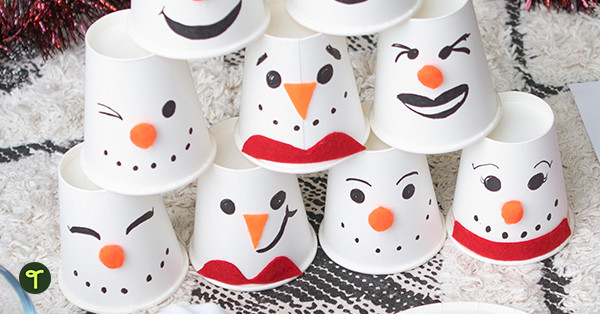Cups decorated for a snowman bowling game for kids, piled in a pyramid