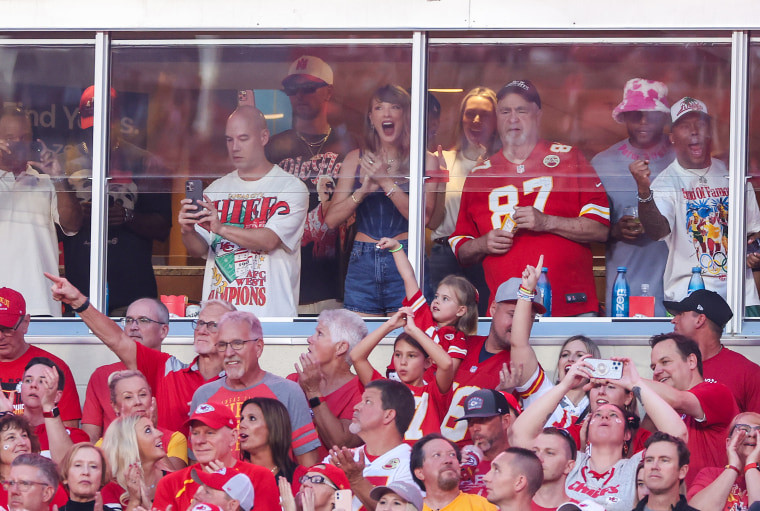 Taylor Swift cheers on Travis Kelce while seated next to his dad, Ed Kelce, on Sept. 5.