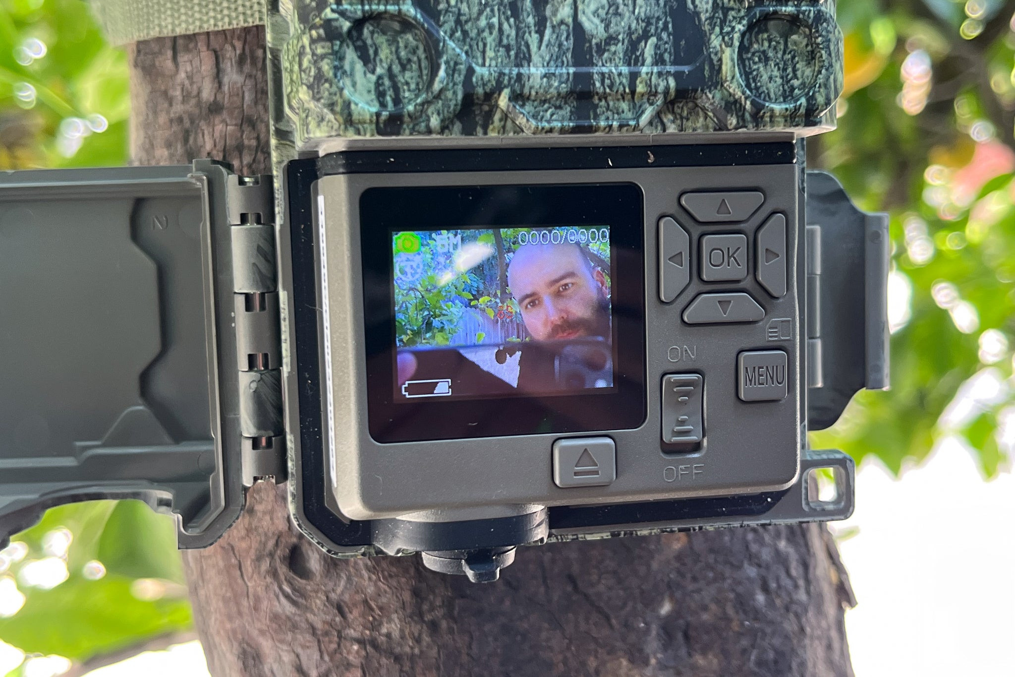 A screen showing someone adjusting the settings on a Bushnell Core S-4K No Glow trail camera.
