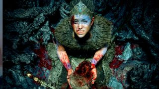 Senua covered in blood and holding skull during Hellblade