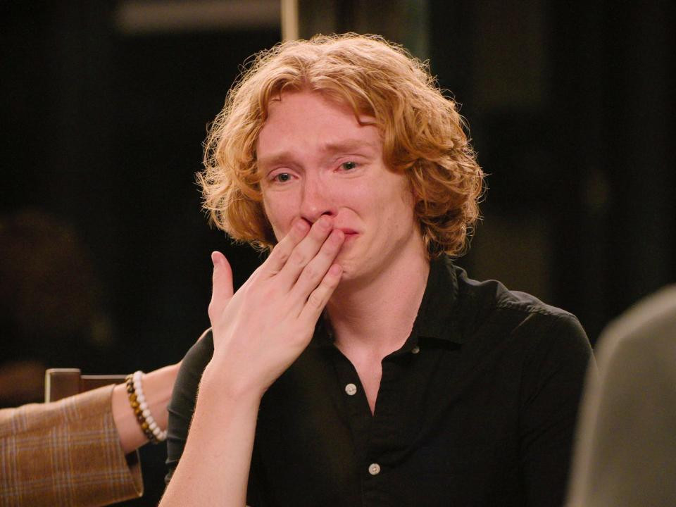 Bryce Lee in tears and has a hand over his mouth in The Trust