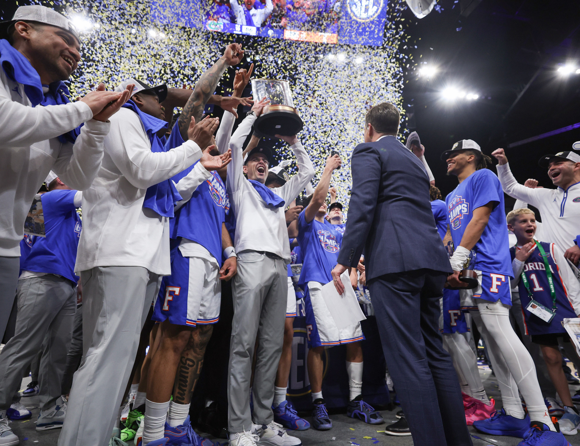 Todd Golden and the Gators on the post-game podium signifying their SEC Championship victory