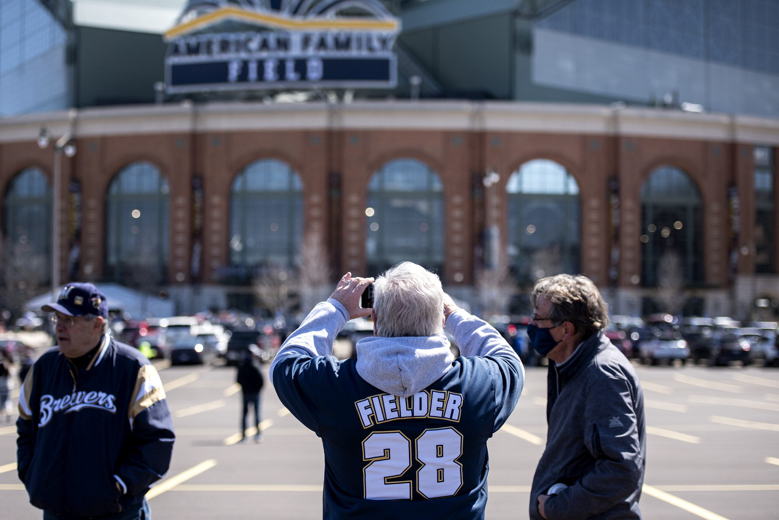 Fans in front of American Family Field, showing anticipation and excitement for the game and highlighting community engagement