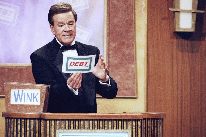 Wink Martindale looks at a card during game show, May 22, 1997.