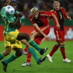 Soccer players in action during an international friendly game, showcasing the intensity and preparation involved.