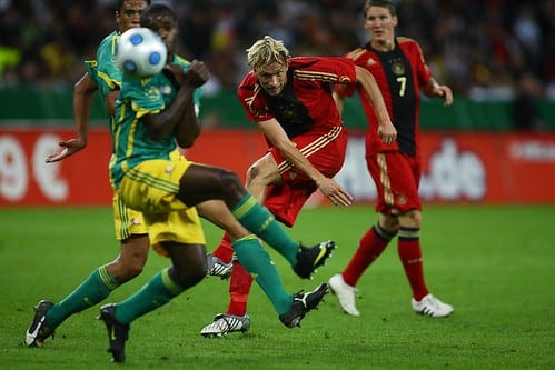 Soccer players in action during an international friendly game, showcasing the intensity and preparation involved.