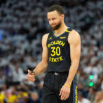 Golden State Warriors guard Stephen Curry (30) gestures during the first half of Game 1 of an NBA basketball second-round playoff series against the Minnesota Timberwolves, Tuesday, May 6, 2025, in Minneapolis. (AP Photo/Abbie Parr)
