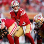 Brock Purdy sets up during the 49ers vs Jets game, wearing the number 13 jersey.
