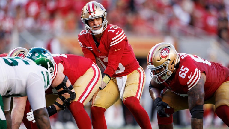 Brock Purdy sets up during the 49ers vs Jets game, wearing the number 13 jersey.