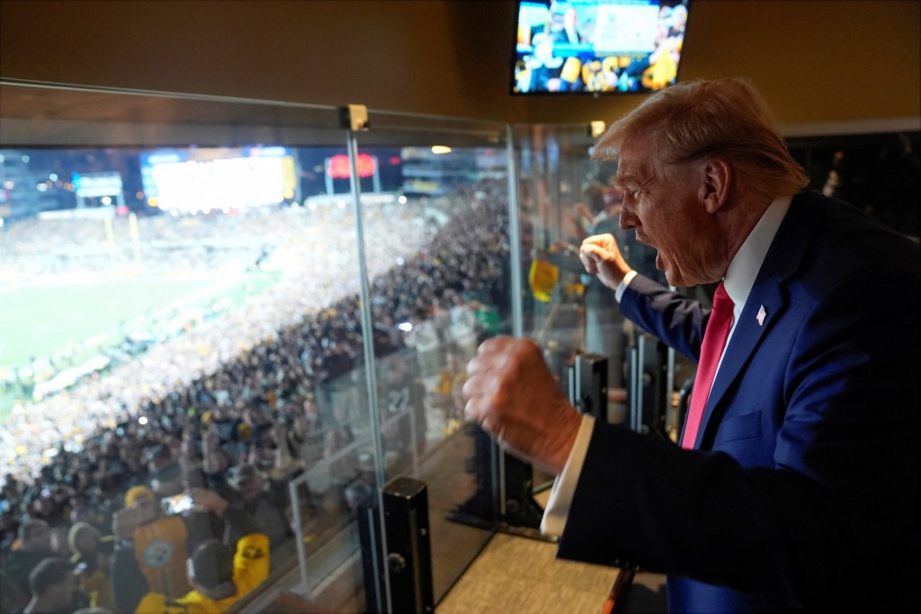 The former president cheers from the suite. via REUTERS