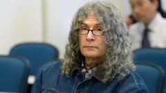 Rodney Alcala during sentencing in 2010, wearing a denim jacket and checked shirt, his long curly grey hair visible