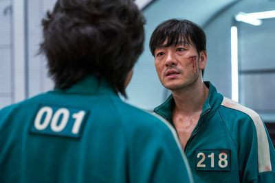Park Hae-soo as Cho Sang-woo, or player 218, with blood on his face in squid game season 1