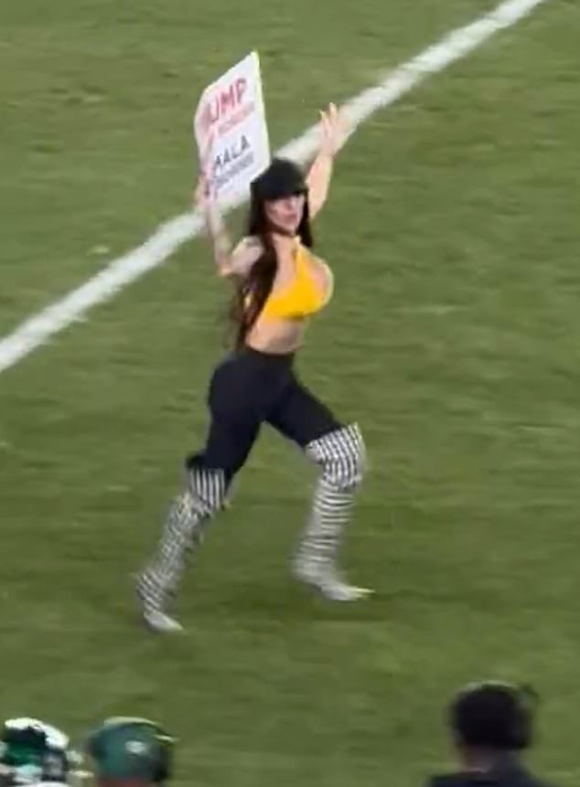 Rose came running onto the field late on in the game at Acrisure Stadium while waving a pro-Trump sign