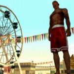 Carl Johnson standing in front of a Ferris wheel in the PS2 game Grand Theft Auto: San Andreas.