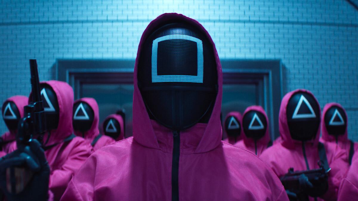 group of people in pink hooded jumpsuits