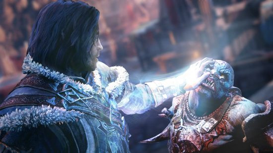 Best action-adventure games - a man places his hand on an orc