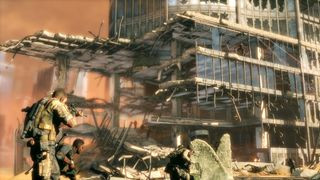 Spec Ops: The Line screenshot of three soldiers taking cover near a rundown building