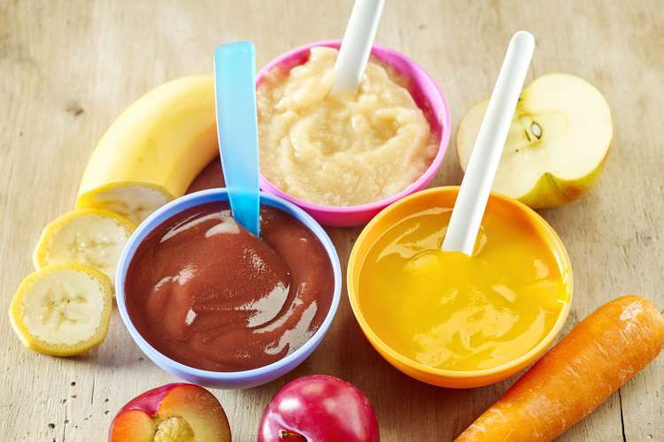 Guests trying to guess the flavor of baby food while blindfolded