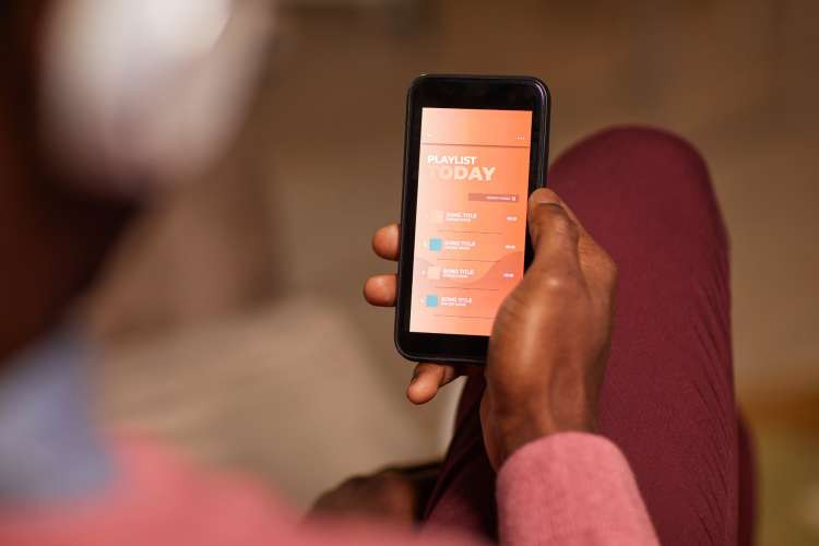 Guests compiling a baby shower playlist with their favorite songs