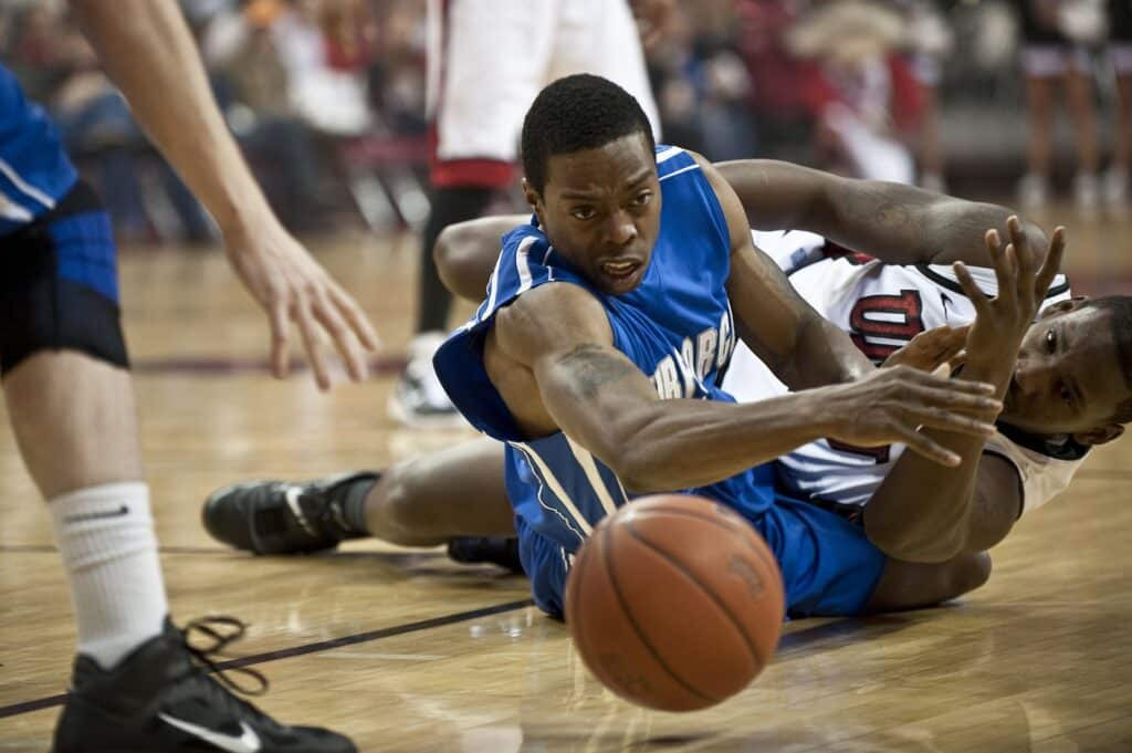 basketball players going for a loose ball