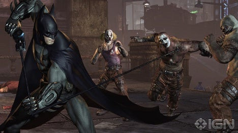 Batman surveying Arkham City from a rooftop, highlighting the expansive and detailed environment
