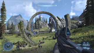 Halo Infinite screenshot of campaign mode, the player holding a large firearm and walking through ancient stone structures in a grassy meadow.