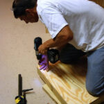 Plywood surface secured to the frame for the bean bag toss game.