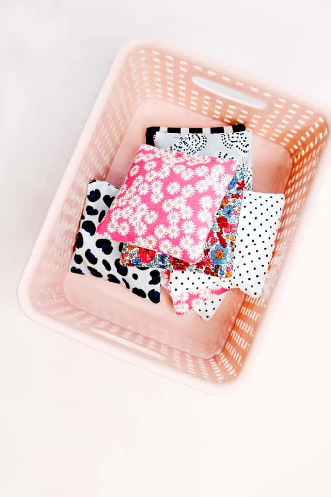 Cutting fabric squares for bean bags, showcasing colorful cotton scraps and a rotary cutter