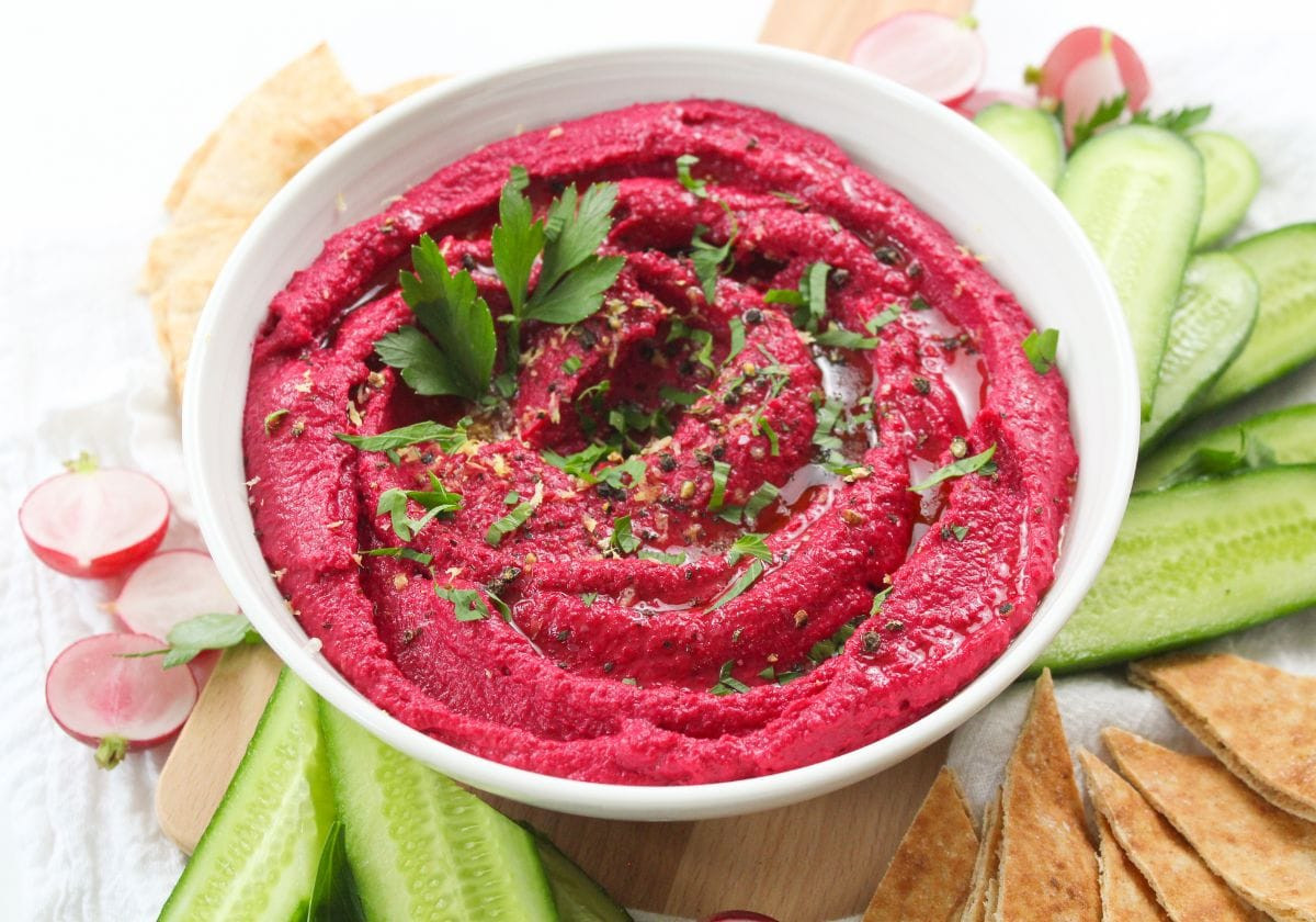 Beetroot hummus with cucumbers, radishes, and pita bread