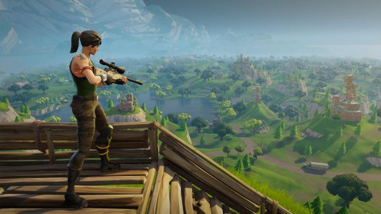 A person standing with a gun on a wooden structure in the woods in Fortnite, which needs no introduction.