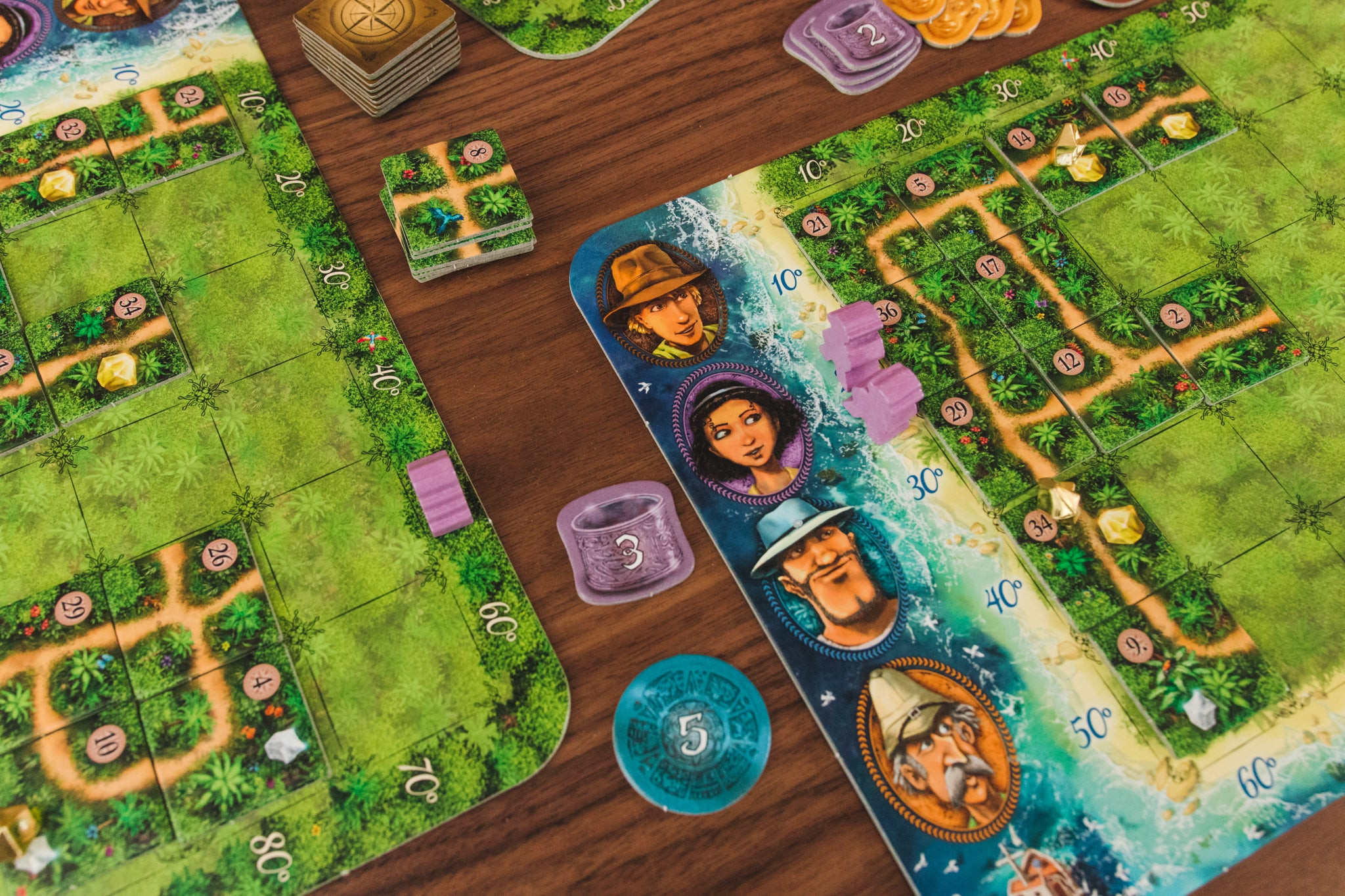 The Karuba board game displayed on a wooden table.