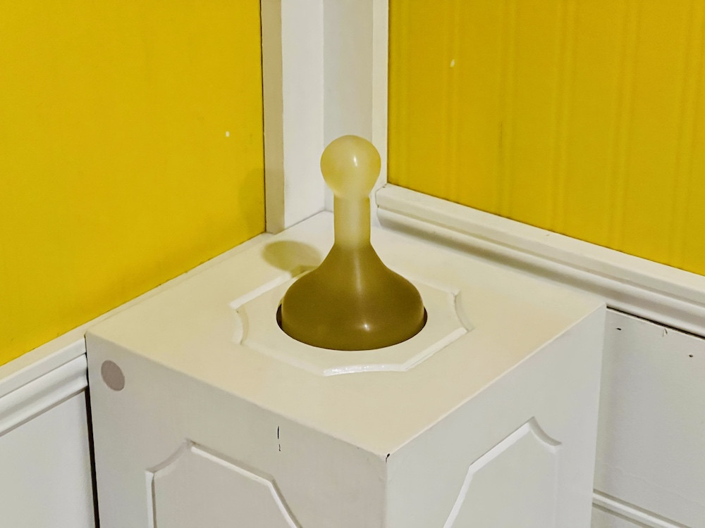 A Clue game piece on a pedestal.