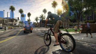 Grand Theft Auto 5 screenshot showing a character riding a bicycle on the road