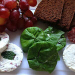 Goat cheese and other cheeses on wooden board